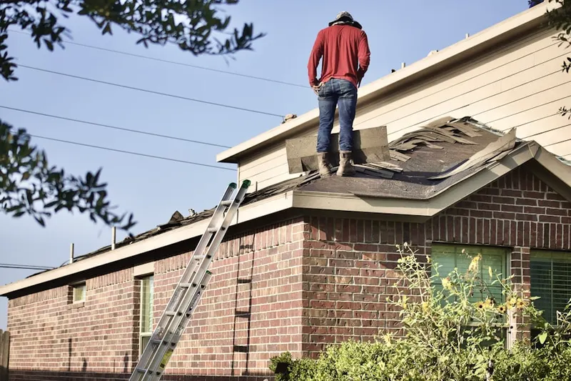 Professional roofer working on a residential roof in Redding Ridge
